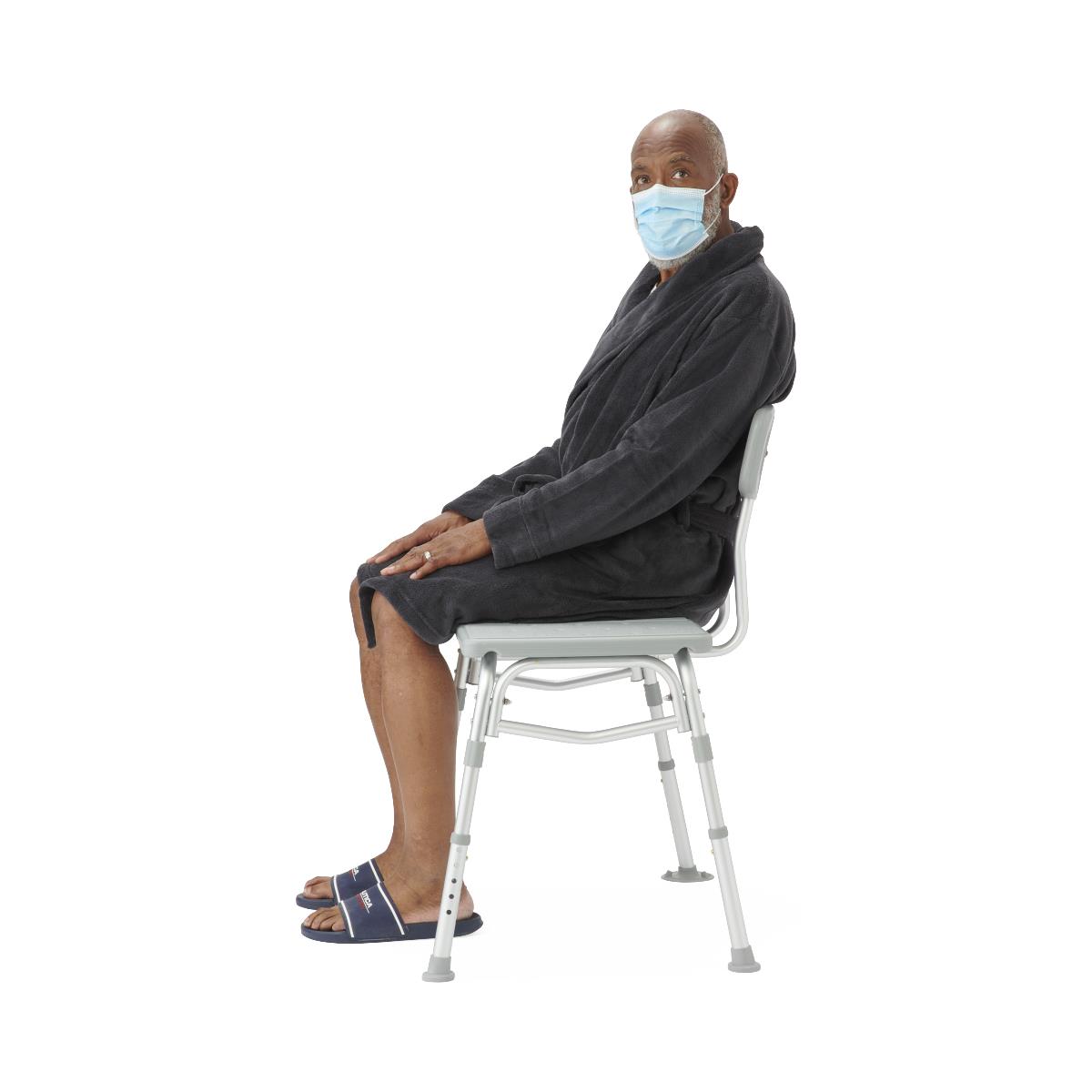 Transfer bath bench with back support, side view in a bathroom setting.