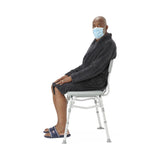 Transfer bath bench with back support, side view in a bathroom setting.