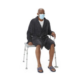 Transfer bath bench with back support, showing suction cup feet for stability.