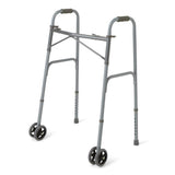 Medline Guardian bariatric folding walker with wheels, front view, in use.